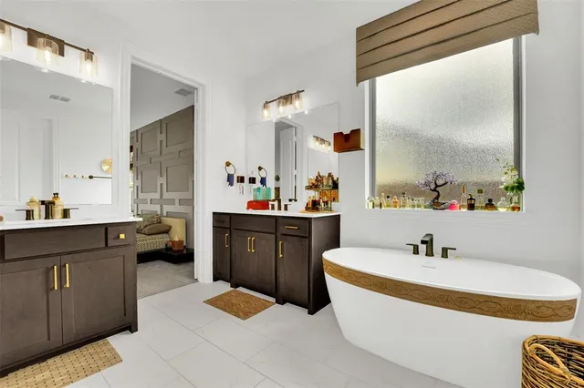 a bathroom with a tub sink and mirror