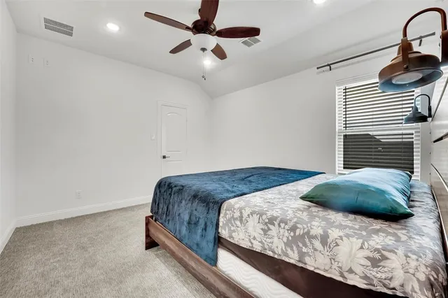 a bedroom with a bed dresser and a window