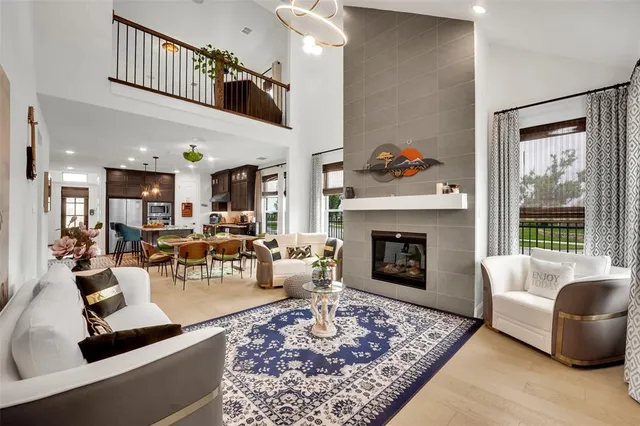 a living room with furniture a rug and a fireplace
