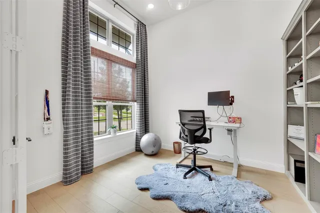 a view of workspace with a window and gym cycle