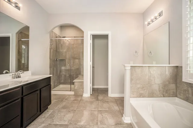 a bathroom with a bathtub and a sink