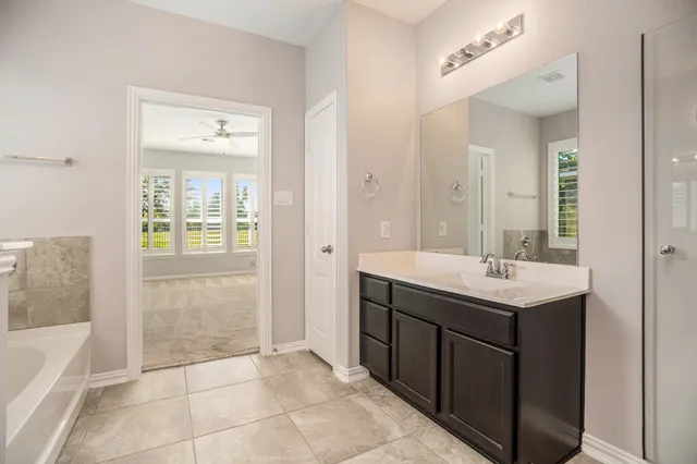 a bathroom with a sink a mirror and a bathtub