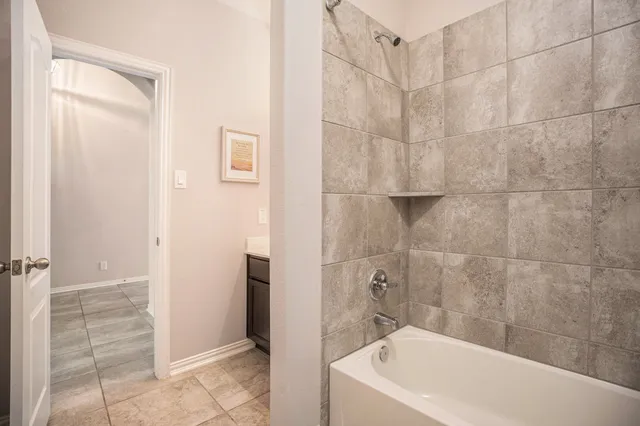 a bathroom with a bathtub and shower