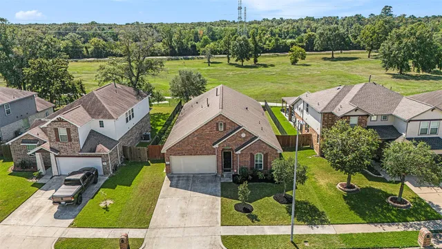 an aerial view of a house with big yard