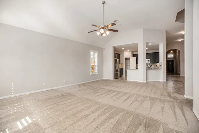 a view of a kitchen with a sink and a chandelier fan