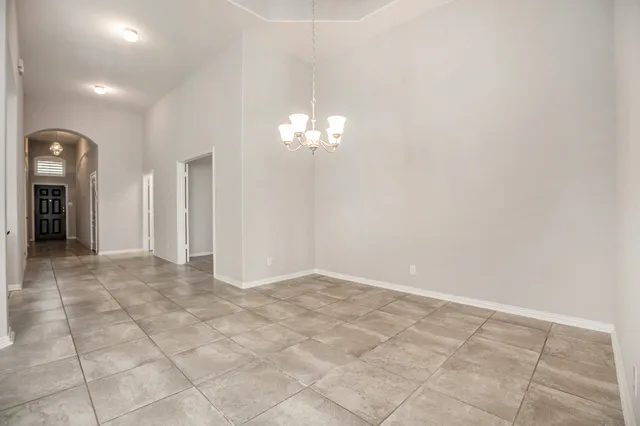 a view of a hallway with chandelier