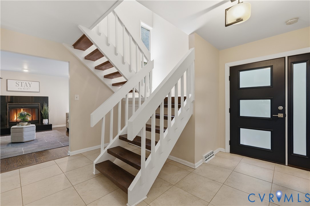 13622 Winterberry Ridge Midlothian, VA 23112 - Photo 4 of 47 a view of staircase with lots of frames and a rug