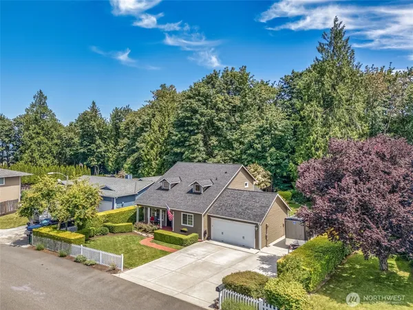 an aerial view of a house with a yard basket ball court and outdoor seating