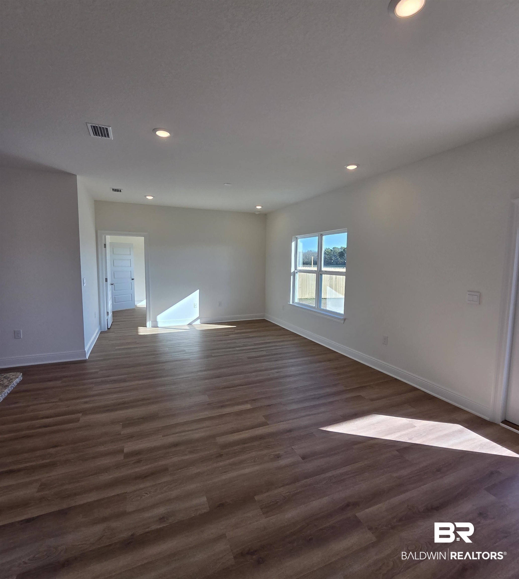 28084 Hallow Trail Elberta, AL 36530 - Photo 7 of 21 Empty room featuring recessed lighting and dark wood-type flooring