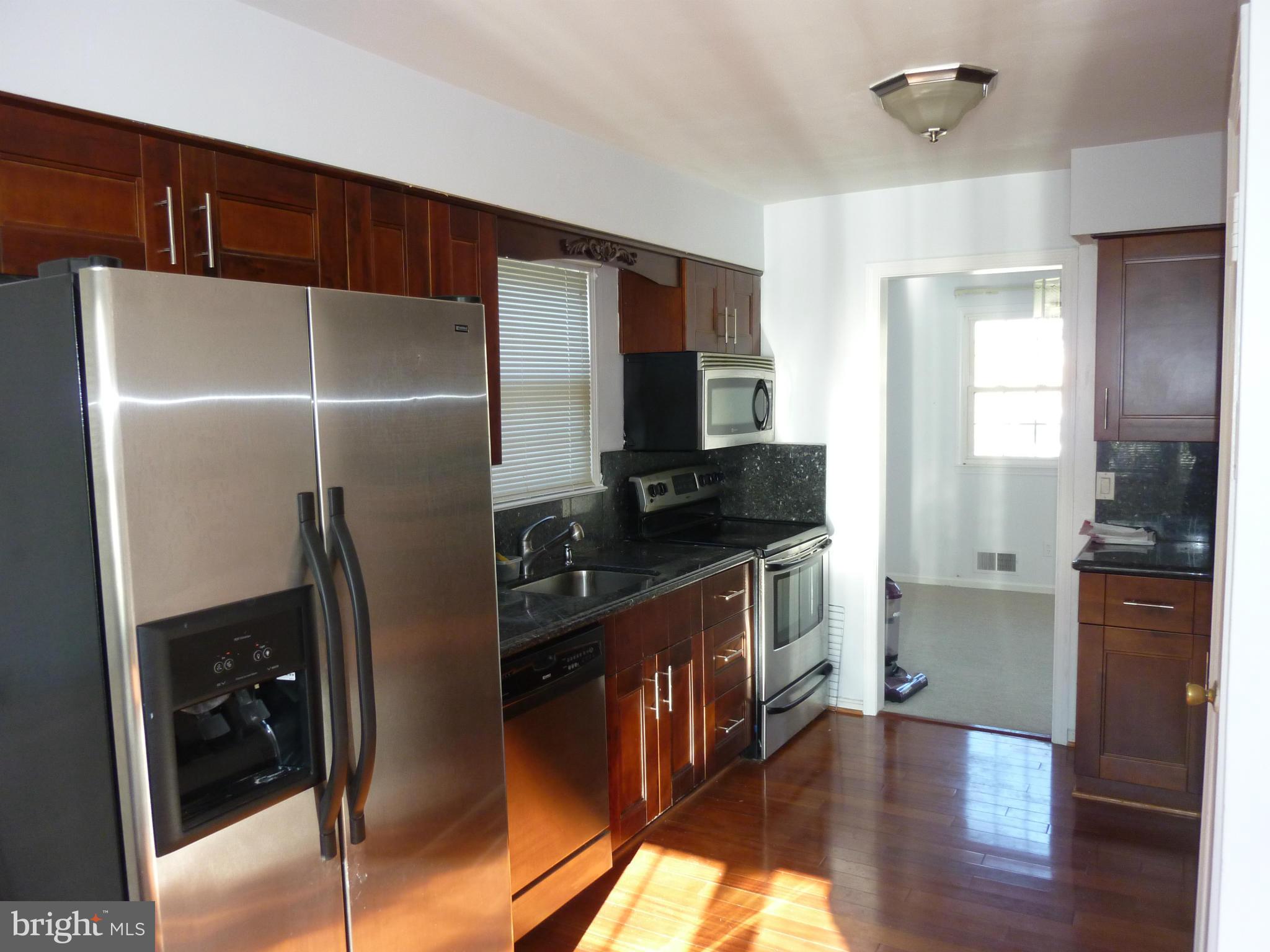 1936 Powder Mill Road Silver Spring, MD 20903 - Photo 3 of 4 a kitchen with stainless steel appliances a refrigerator and a stove top oven