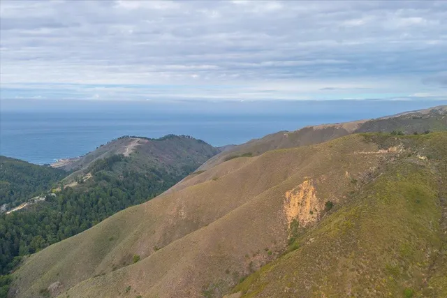 a view of an ocean and mountains