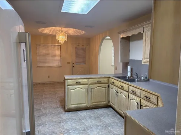 a spacious bathroom with a granite countertop sink a mirror and shower