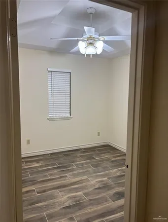 a view of a chandelier fan and wooden floor
