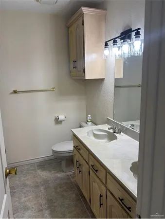 a bathroom with a sink a toilet and mirror
