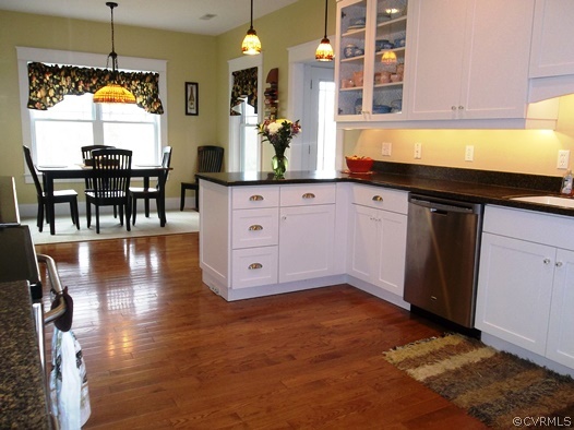 1928 Chinquapin Road Prospect, VA 23960 - Photo 3 of 24 a kitchen with stainless steel appliances granite countertop a stove a sink a dining table and chairs with wooden floor