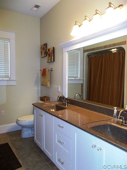 1928 Chinquapin Road Prospect, VA 23960 - Photo 6 of 24 a bathroom with a granite countertop toilet a sink and mirror