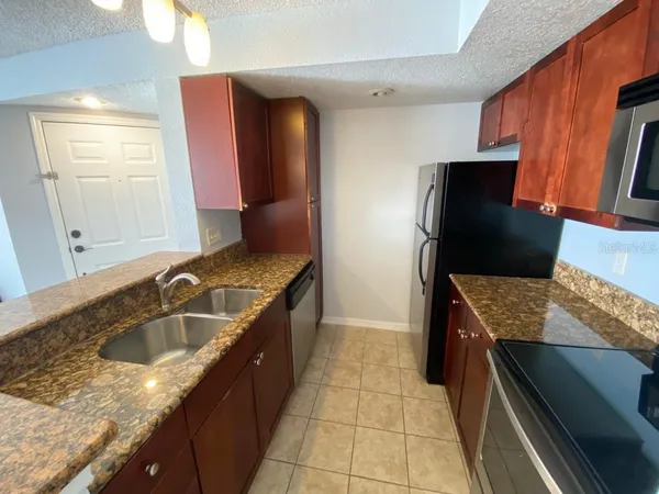 a kitchen with a sink and a refrigerator