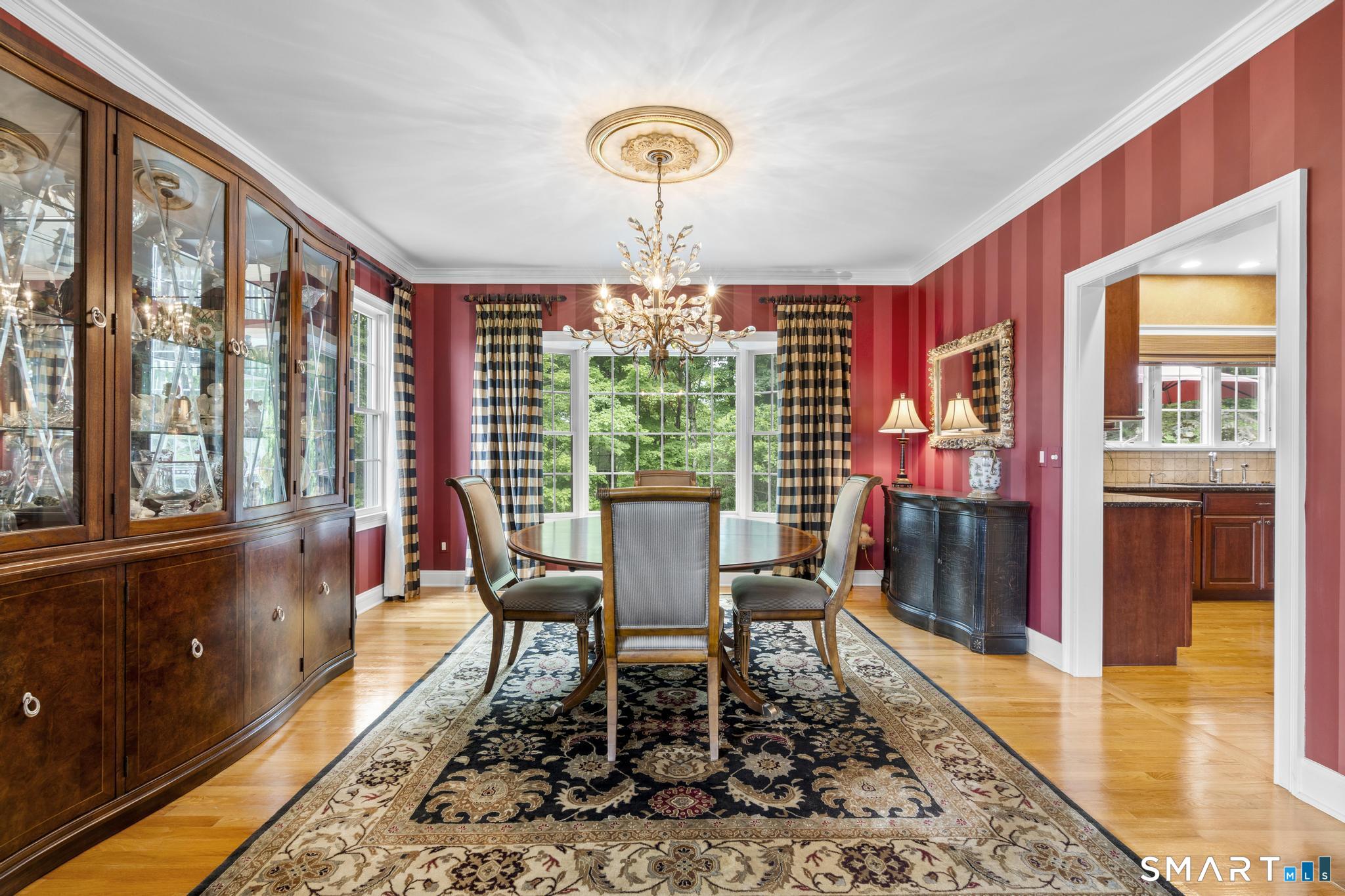 12 Logans Way Danbury, CT 06811 - Photo 15 of 40 a dining room with furniture a chandelier and wooden floor