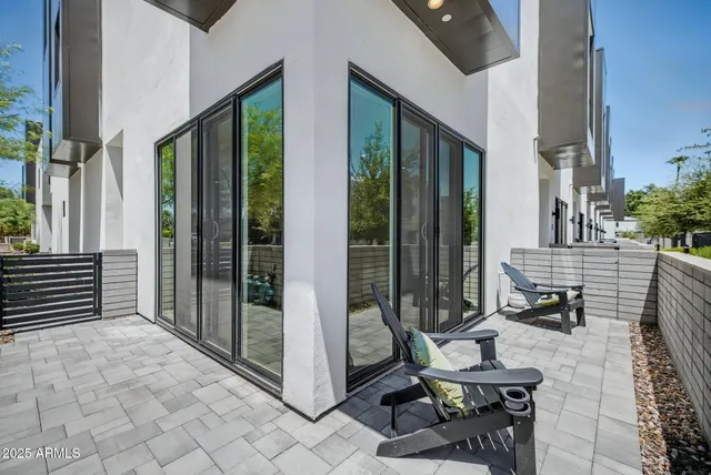 a view of a balcony with chair and the floor to ceiling window