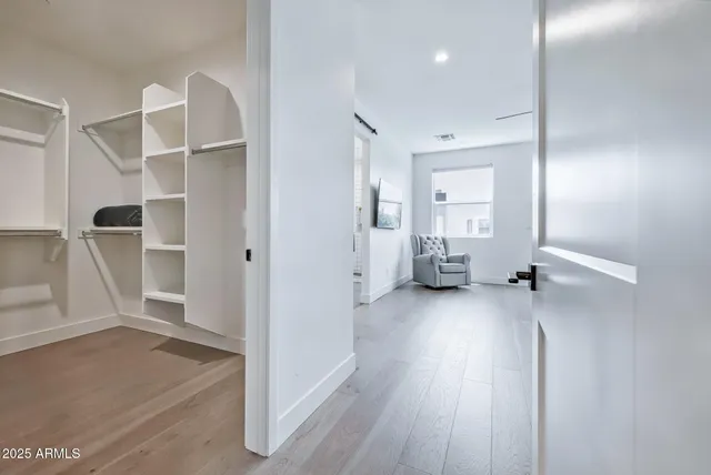 a view of a room with wooden floor and windows