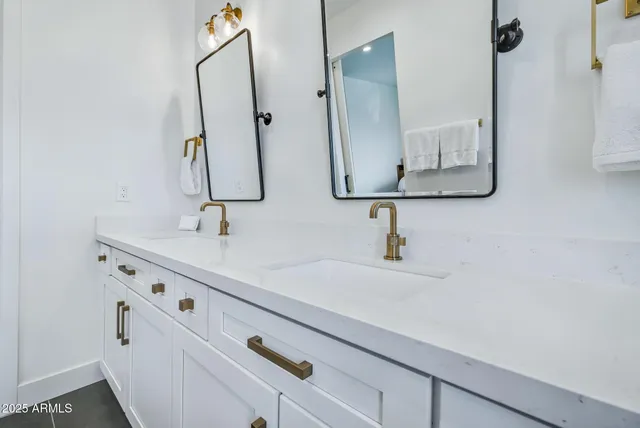 a bathroom with a sink and mirror