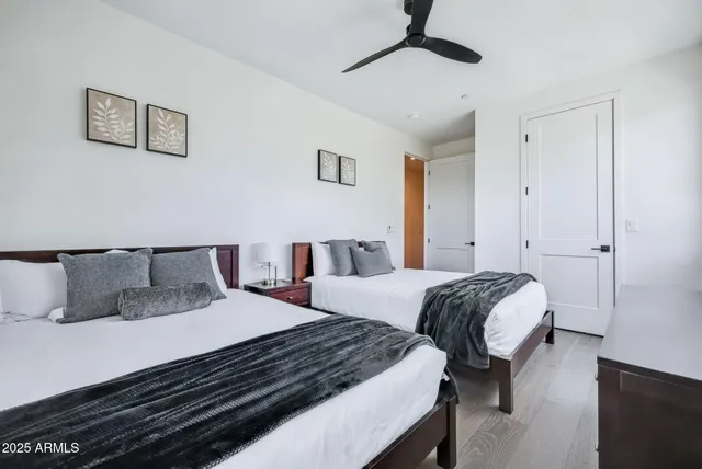 a bedroom with two beds and a chandelier