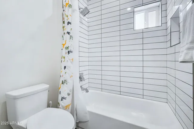 a bathroom with a toilet and shower