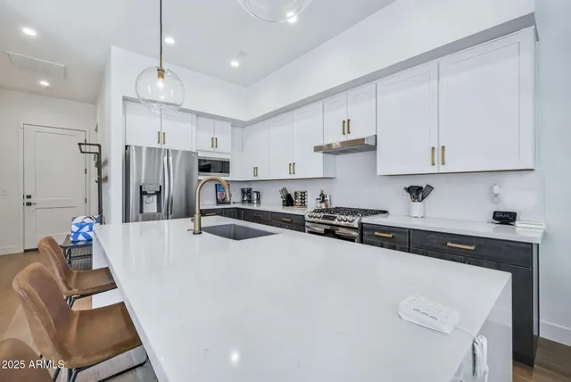 a kitchen with a refrigerator a stove a sink and a refrigerator