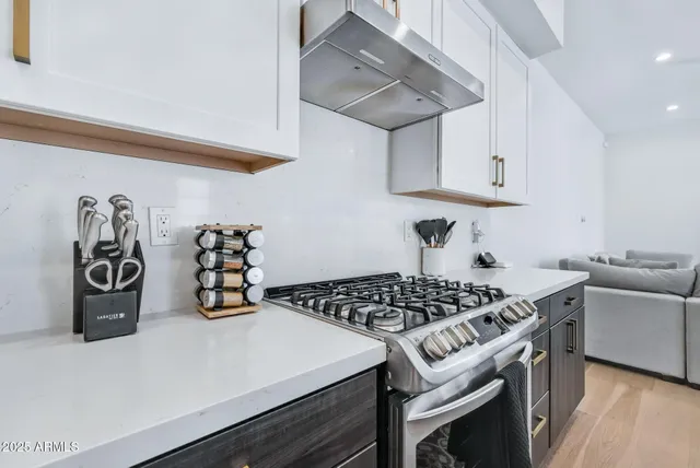 a kitchen with a stove and cabinets