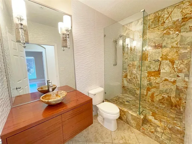 a bathroom with a sink toilet and shower