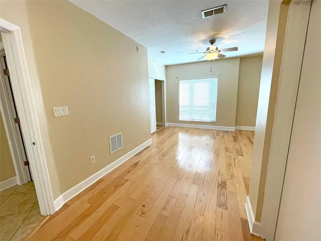 a view of a room with wooden floor and staircase