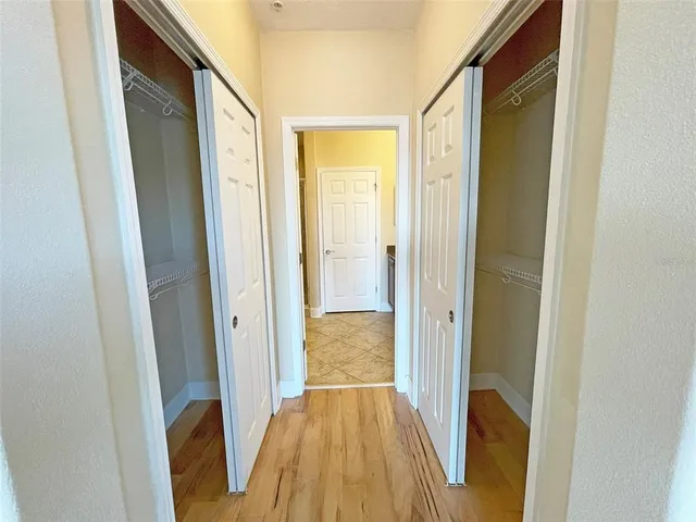 a view of hallway with wooden floor