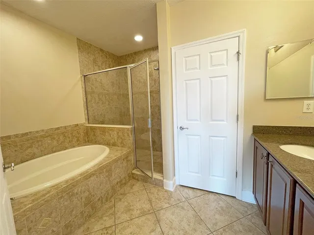a bathroom with a tub a sink and a shower