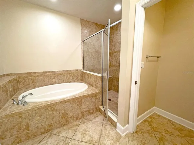 a bathroom with a tub and shower