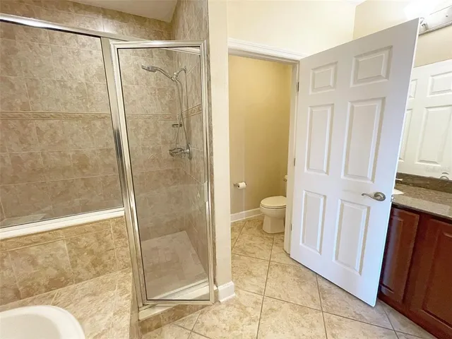a bathroom with a glass door shower