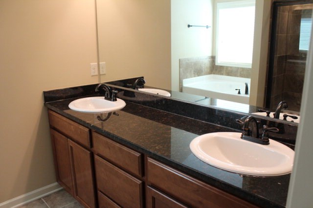 9300 Yarbrough Road Midland, GA 31820 - Photo 12 of 18 a bathroom with a double vanity sink and a mirror
