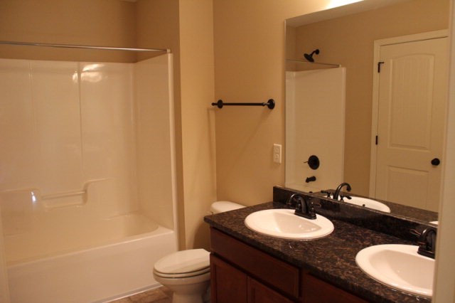 9300 Yarbrough Road Midland, GA 31820 - Photo 15 of 18 a bathroom with a granite countertop sink toilet and shower