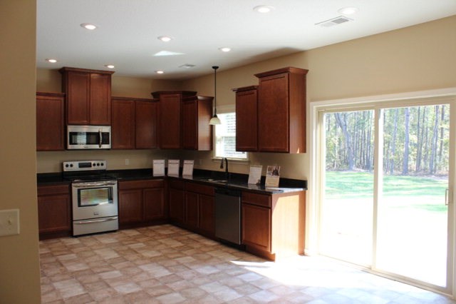 9300 Yarbrough Road Midland, GA 31820 - Photo 6 of 18 a kitchen with stainless steel appliances granite countertop a stove sink and cabinets