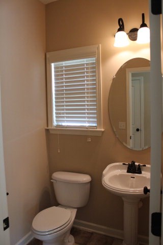 9300 Yarbrough Road Midland, GA 31820 - Photo 9 of 18 a bathroom with a toilet a sink and mirror