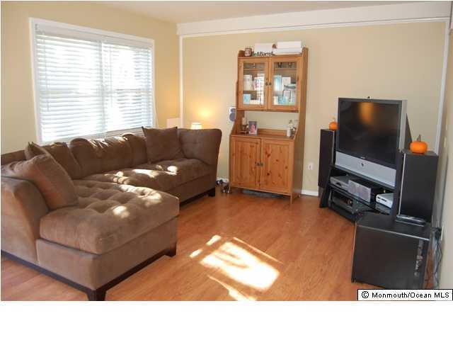 130 Greenwood Loop Road Brick, NJ 08724 - Photo 2 of 3 a living room with furniture and a flat screen tv