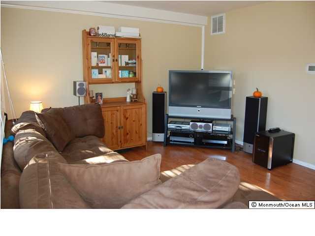 130 Greenwood Loop Road Brick, NJ 08724 - Photo 3 of 3 a living room with furniture and a flat screen tv