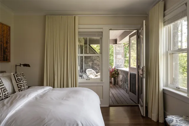 a bedroom with a large bed and a large window with outer view