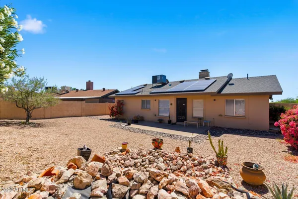 a view of a road with a house in the background