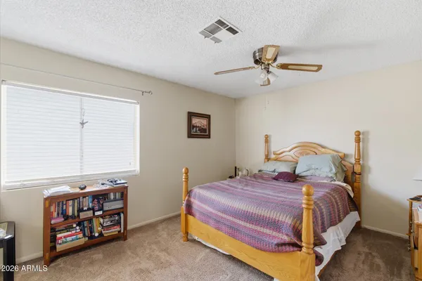 a bedroom with a bed and a tv