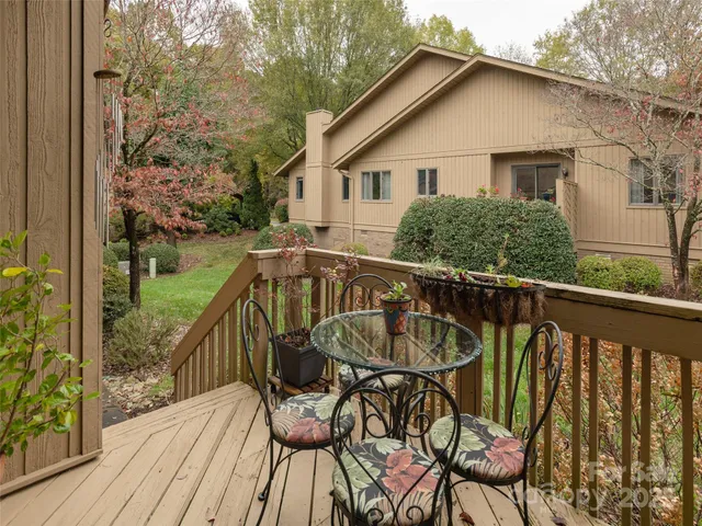 a view of a wooden chairs on roof deck