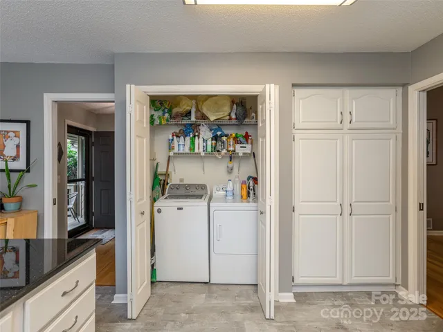 a view of kitchen with refrigerator and window