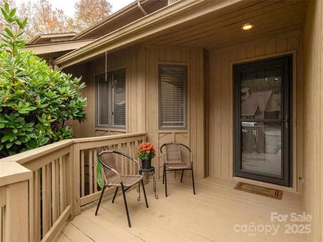 a view of a chair and table in front of a house