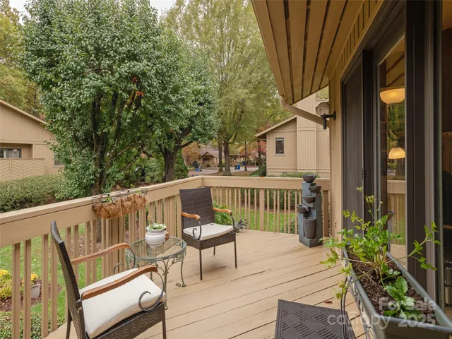 a view of balcony with wooden floor and outdoor seating