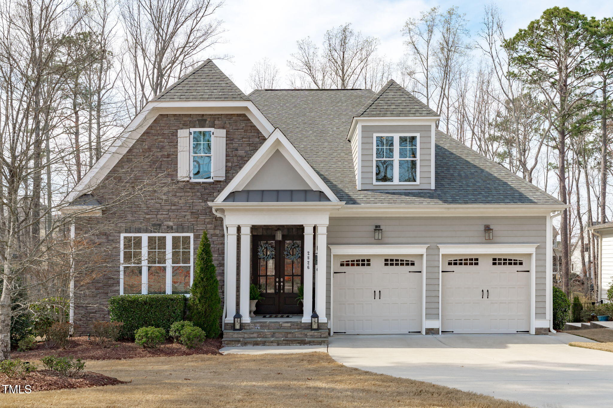 2826 Walden Road Apex, NC 27502 - Photo 1 of 50 a front view of a house with a yard and garage