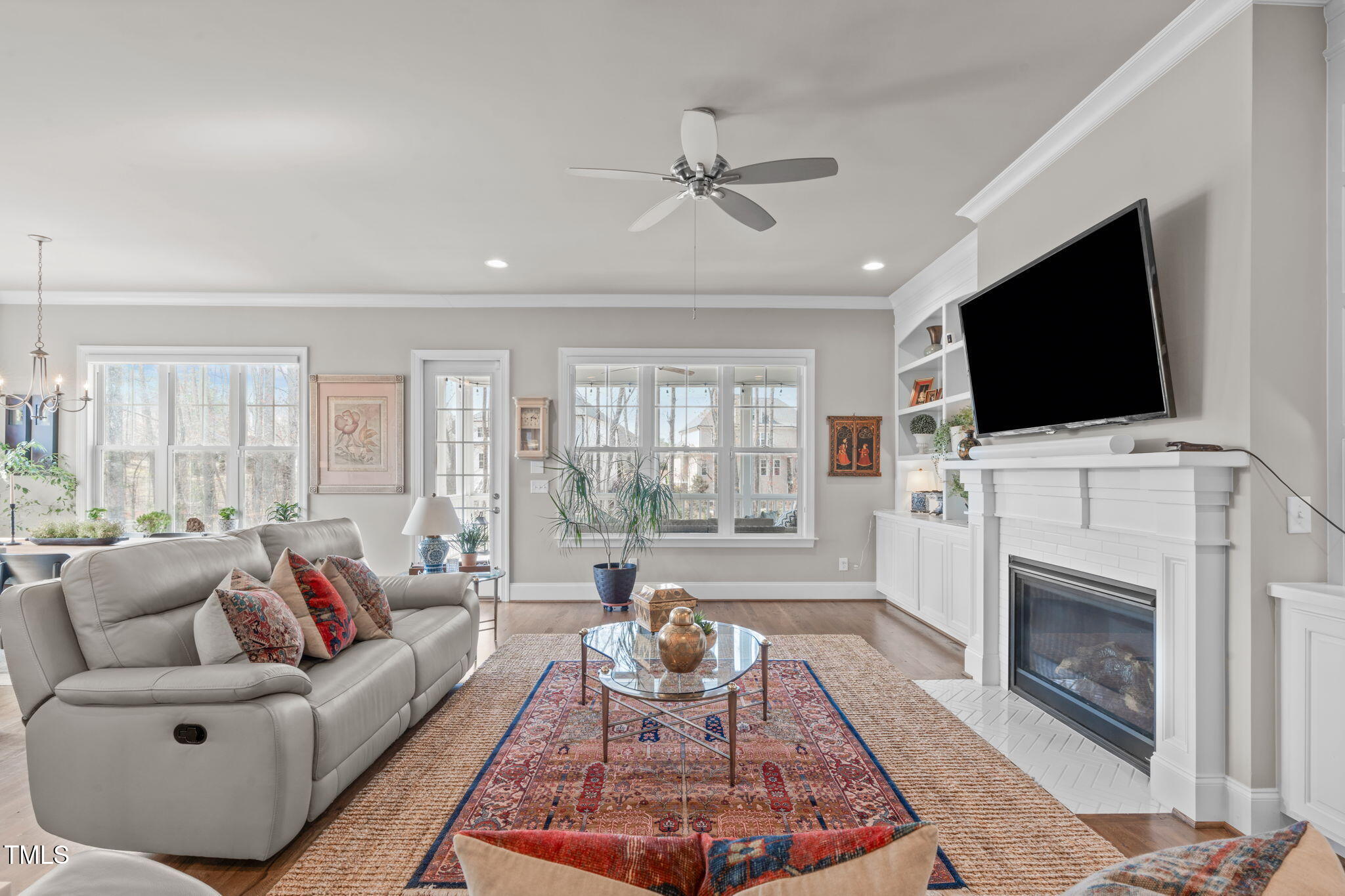 2826 Walden Road Apex, NC 27502 - Photo 12 of 50 a living room with furniture a flat screen tv and a fireplace